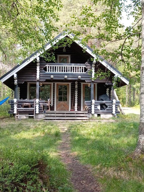 a log cabin in the middle of a forest at Rantarinne 543 B in Kuusamo