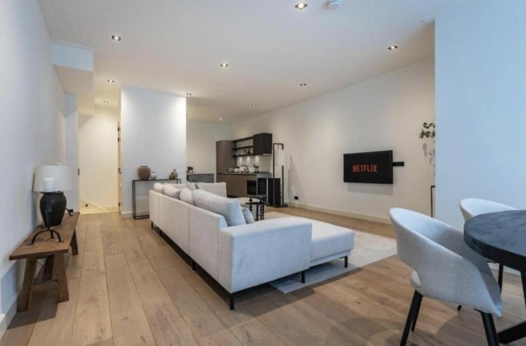 a living room with a white couch and a table at Charming Stay De Pijp at Centrum in Amsterdam
