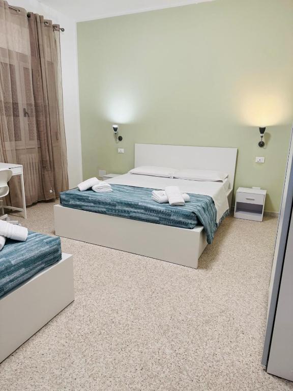 a bedroom with a large bed and a table at MMM HOME Train Station 1 in Venice
