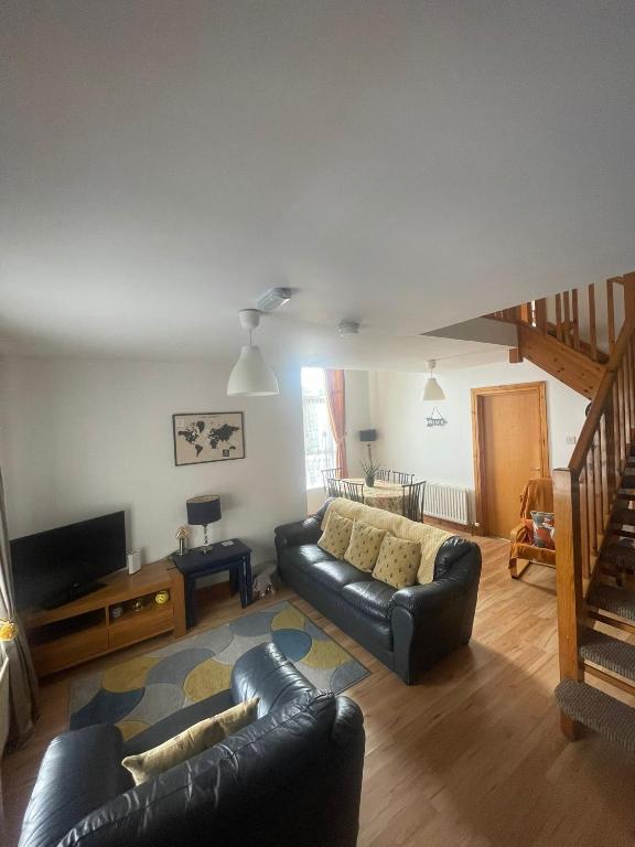 a living room with a couch and a television at Portstewart Escape in Portstewart