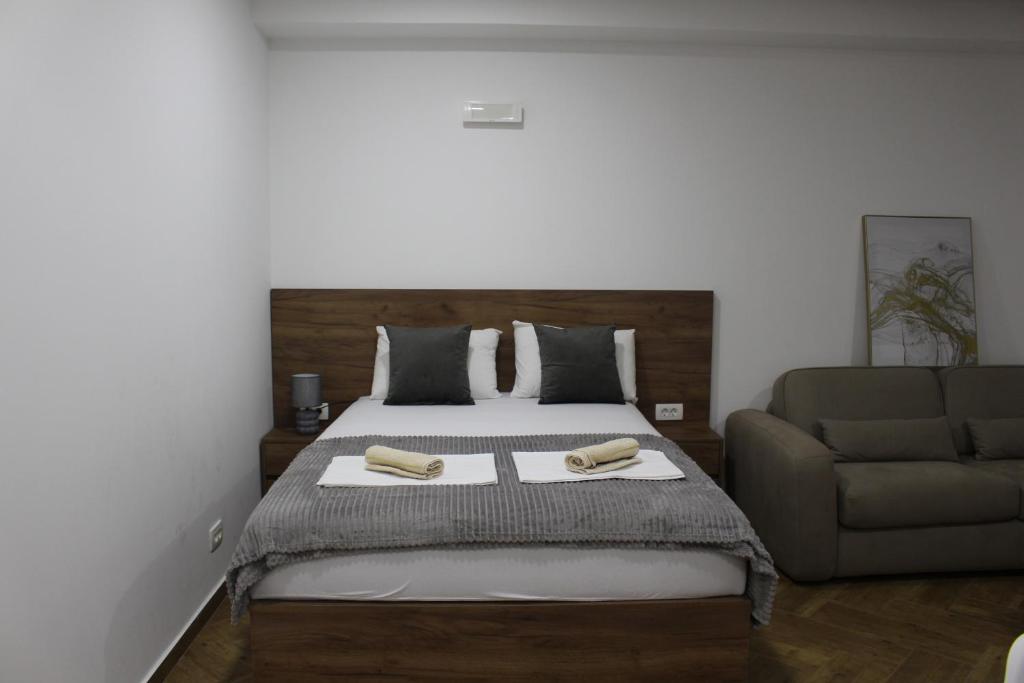 a bedroom with a bed and a couch at AMD - garsonjera 312 in Dobra Voda