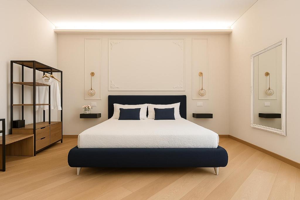 a bedroom with a king sized bed and a mirror at Sea Pearl Luxury Rooms in La Spezia