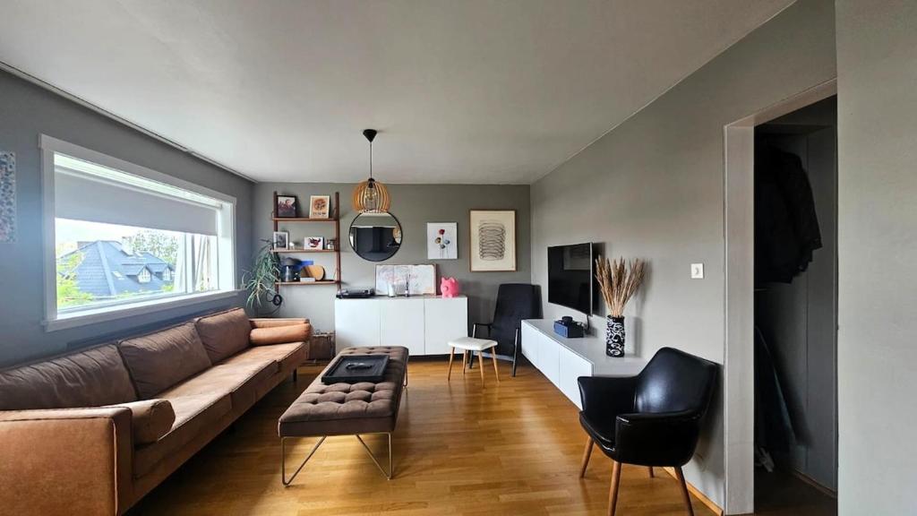 a living room with a couch and a table at Your Icelandic home in Reykjavik in Reykjavík