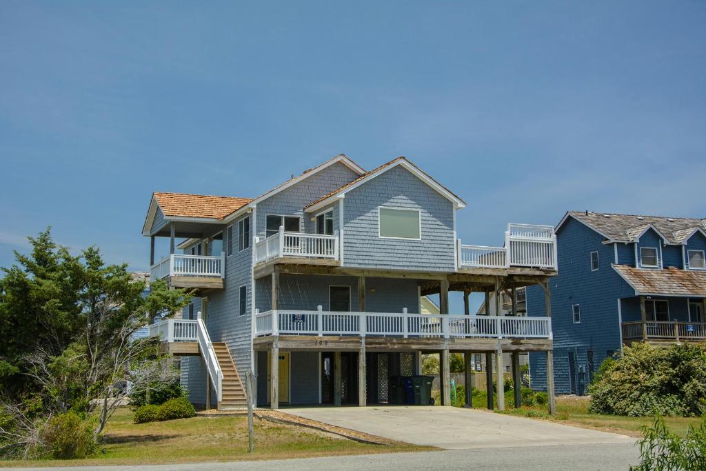 a large house with balconies on a street at Seaside 46 in Nags Head