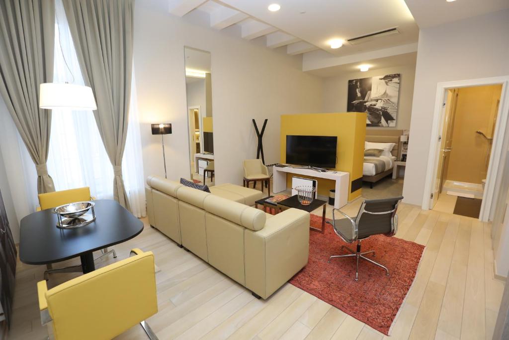 a living room with a couch and a table and a television at Zepter Hotel Belgrade, member of Zepter Hotels in Belgrade