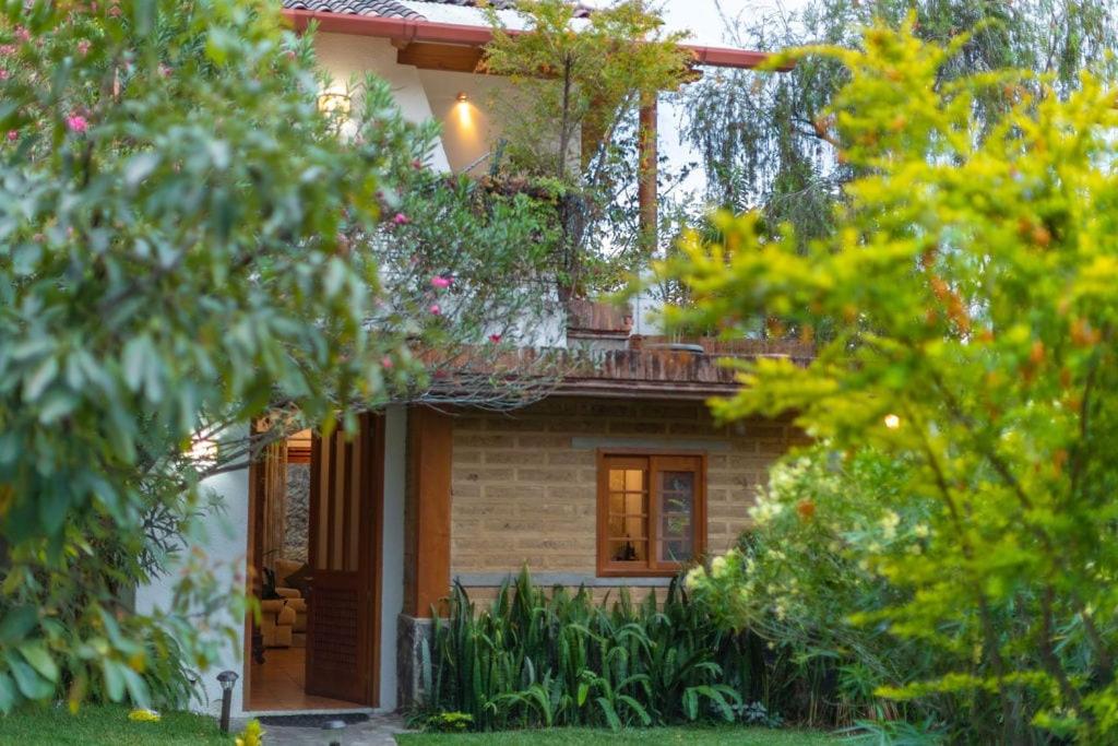 a house with a balcony on top of it at Casa Tropical Atitlán in Panajachel