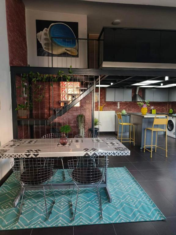 a kitchen with a table and chairs in a room at ColoR Living - loft & yard in Karditsa