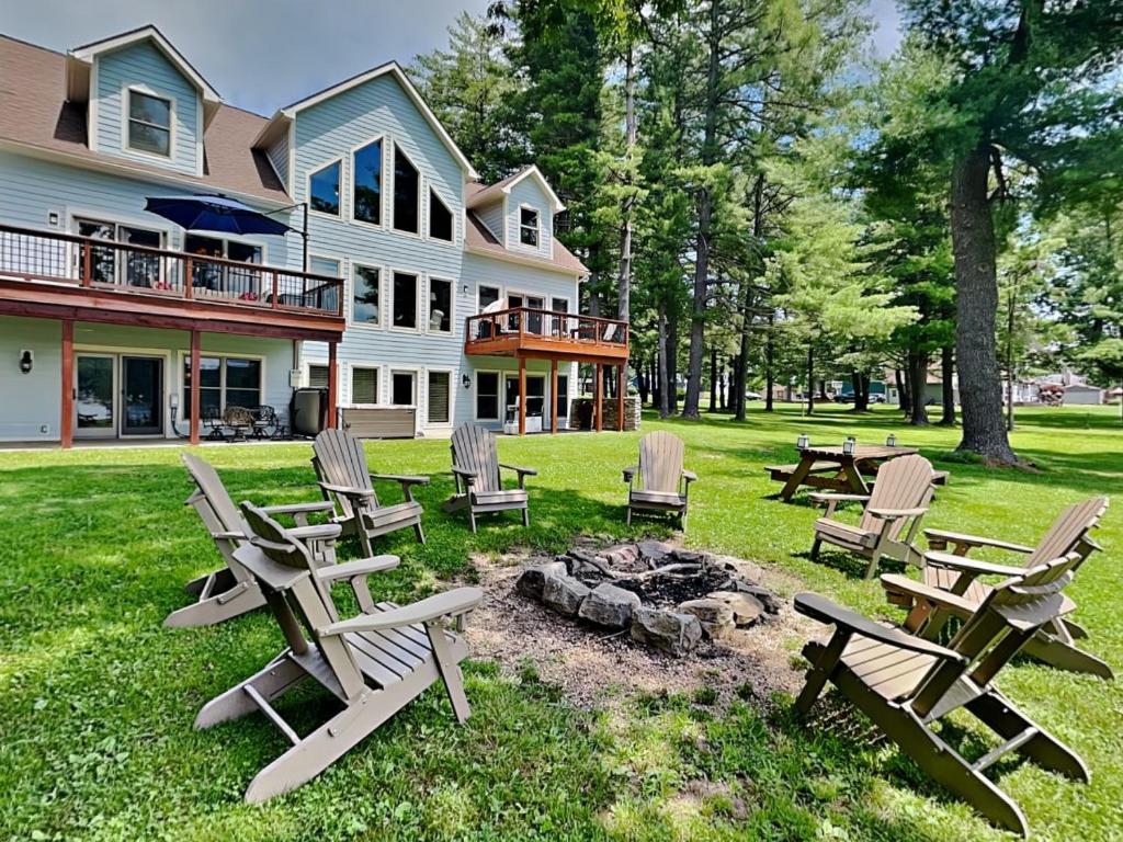 a group of chairs and a fire pit in front of a house at Paravel in Swanton