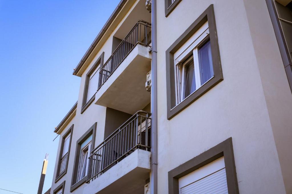 a building with balconies on the side of it at Apartman Tivat in Tivat