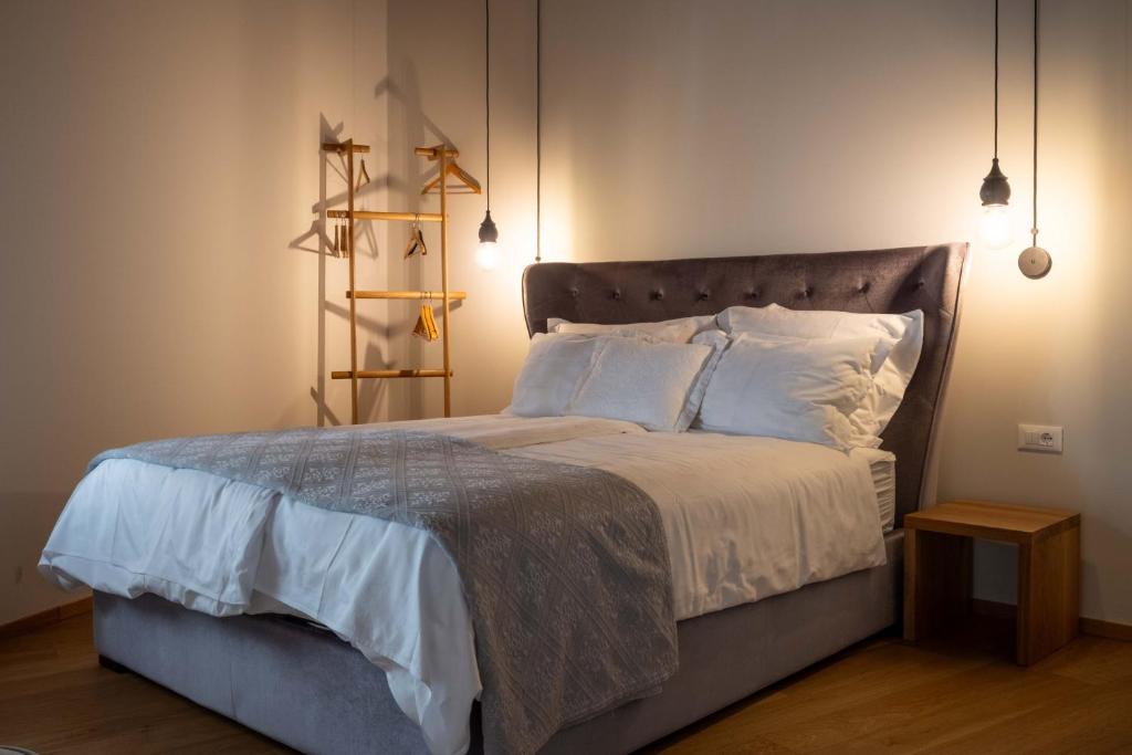 a bedroom with a large bed with white pillows at Suites DANICA in Šmartno