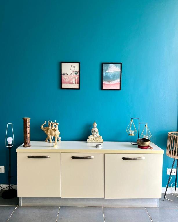 a blue wall with a white dresser in a room at Surfing Ocean View Appartment in Sal Rei