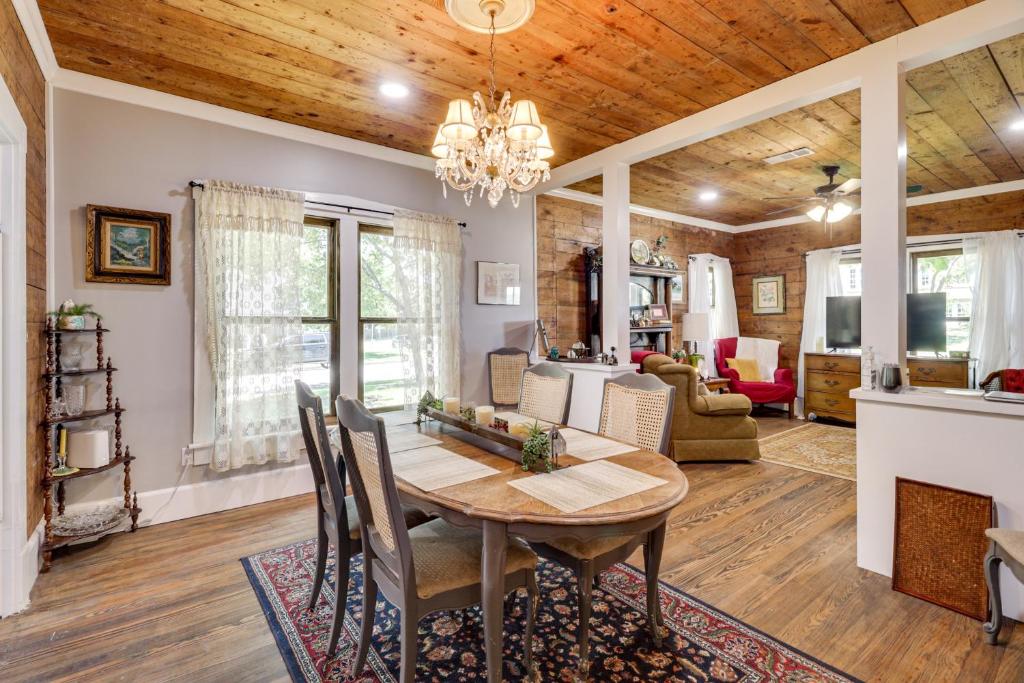 a dining room and living room with a wooden ceiling at 1925 Craftsman Bungalow - 1 Mi to Dtwn Waxahachie! in Waxahachie