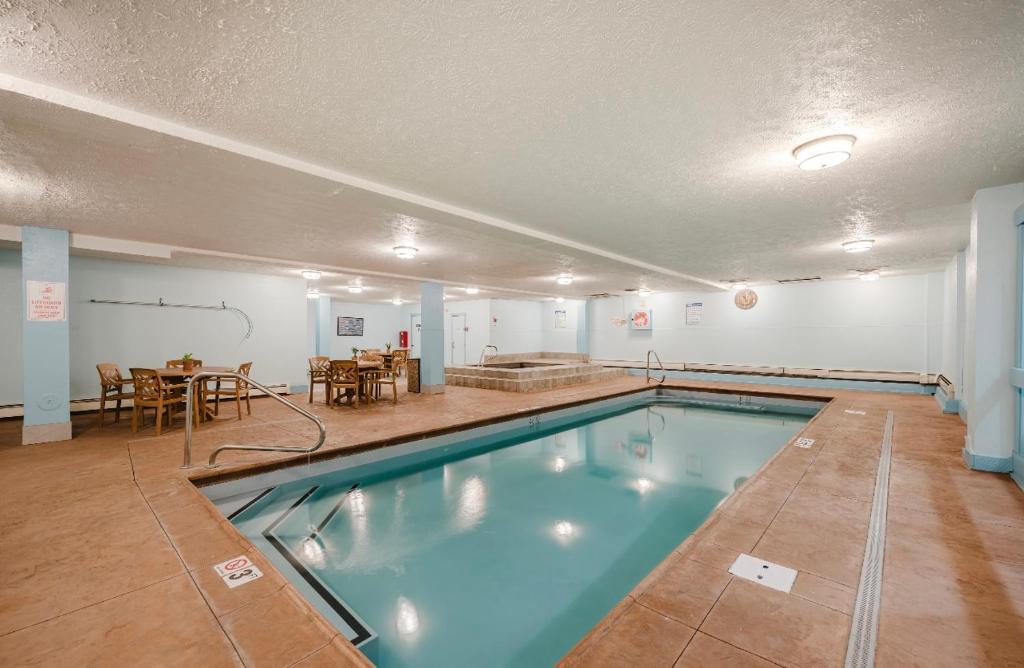 a swimming pool in a room with a table and chairs at LongBranch #116 in Breckenridge