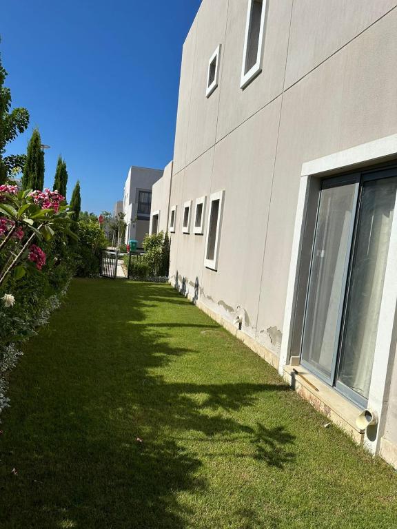 a building with a grass yard next to a building at ريفا فيو in El Alamein