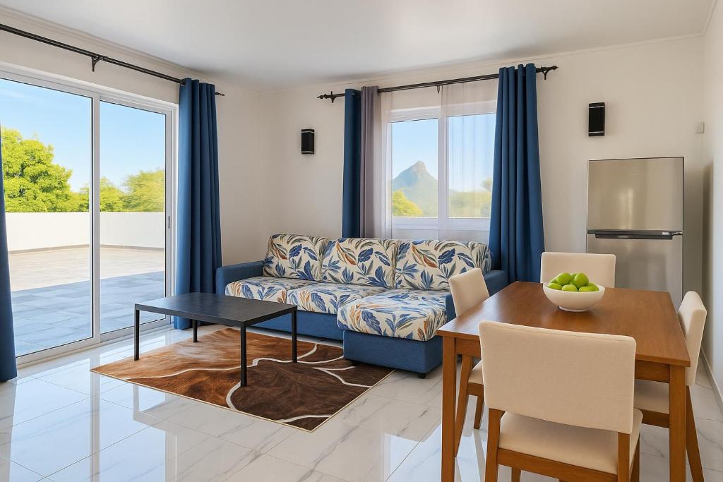 a living room with a couch and a table at Gracious Haven - Fully Equipped Rooftop with private terrace house in Saint-Pierre, Moka in Moka