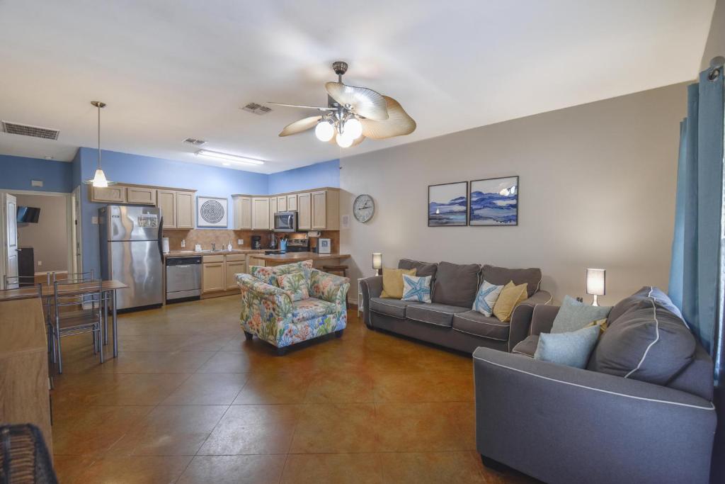 a living room with two couches and a kitchen at Palm Bay 305 in Corpus Christi