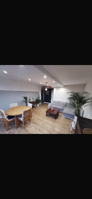 a living room with a table and a couch at Chambre chez nous! Au calme, Montolivet proche métro in Marseille