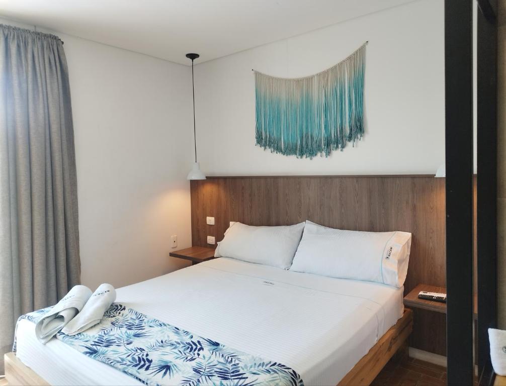 Postel nebo postele na pokoji v ubytování Hotel Macaw Cúcuta