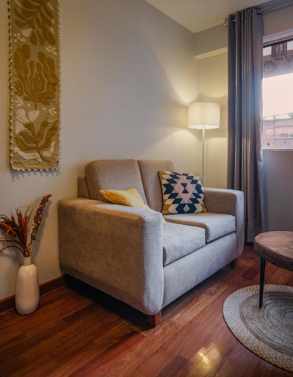 a living room with a couch and a table at Ayra Hotel Boutique in Pisac