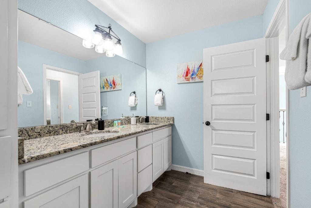 a bathroom with two sinks and a mirror at Sunrise Paradise - Pet Friendly! Community Pool! in Mustang Beach