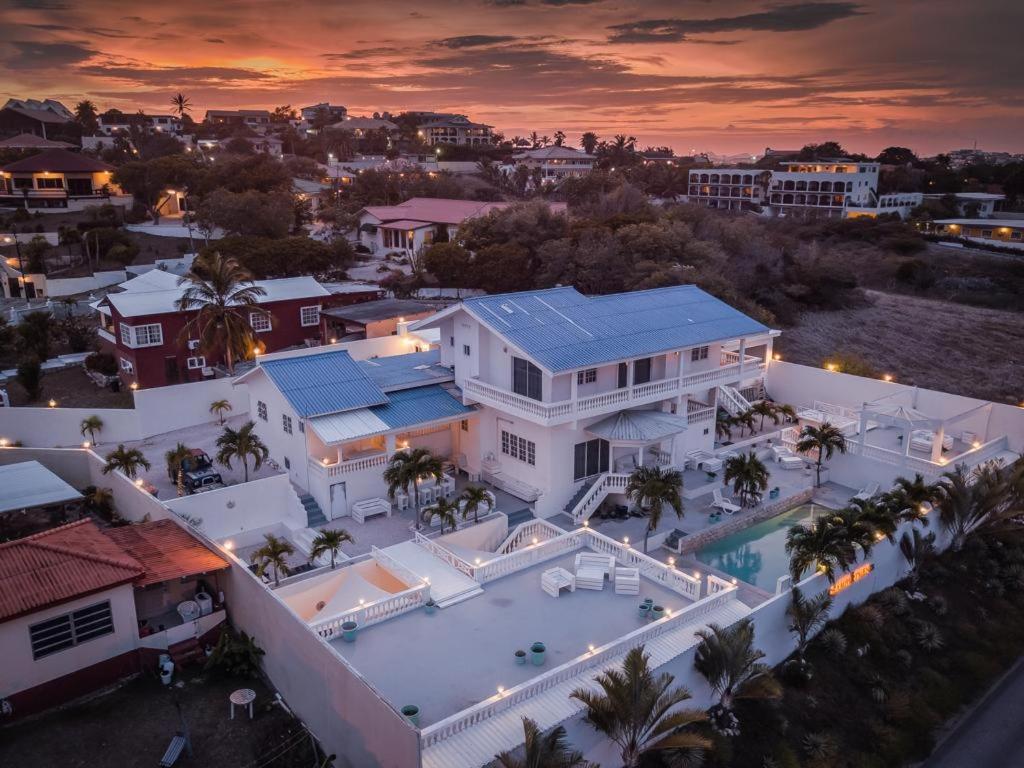 an aerial view of a house with a swimming pool at Group Accommodation Jan Thiel Curaçao in Willemstad