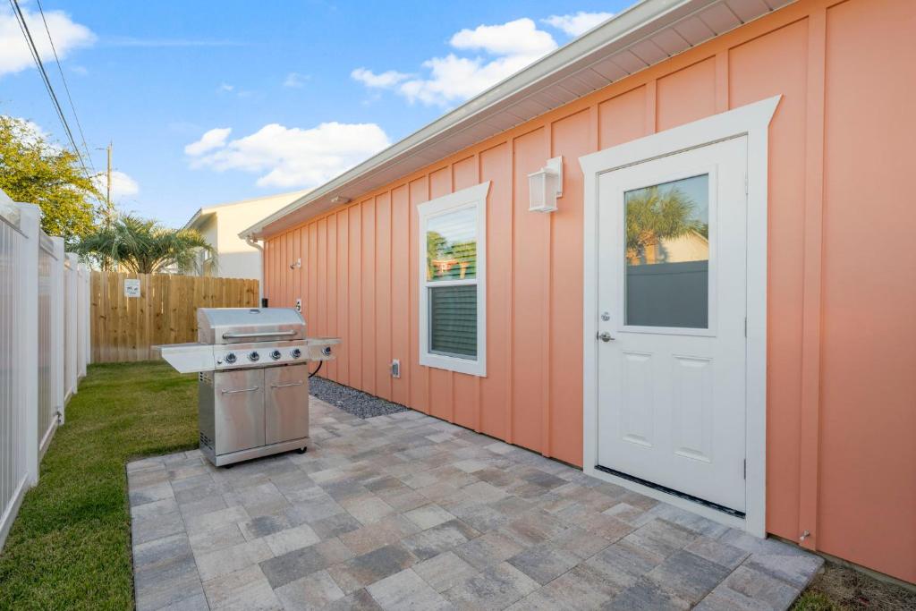 a backyard with an orange building with a stove at Laguna Peach: 3BA 2BA retreat for 10! Explore nearby beaches & activities in Laguna Beach