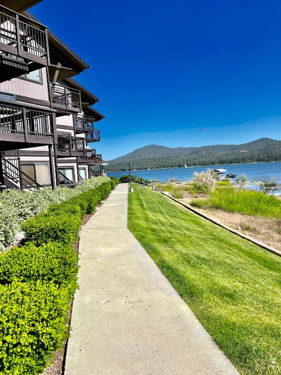 a sidewalk next to a building next to a lake at Forest shores lake view condo #2250 in Big Bear Lake