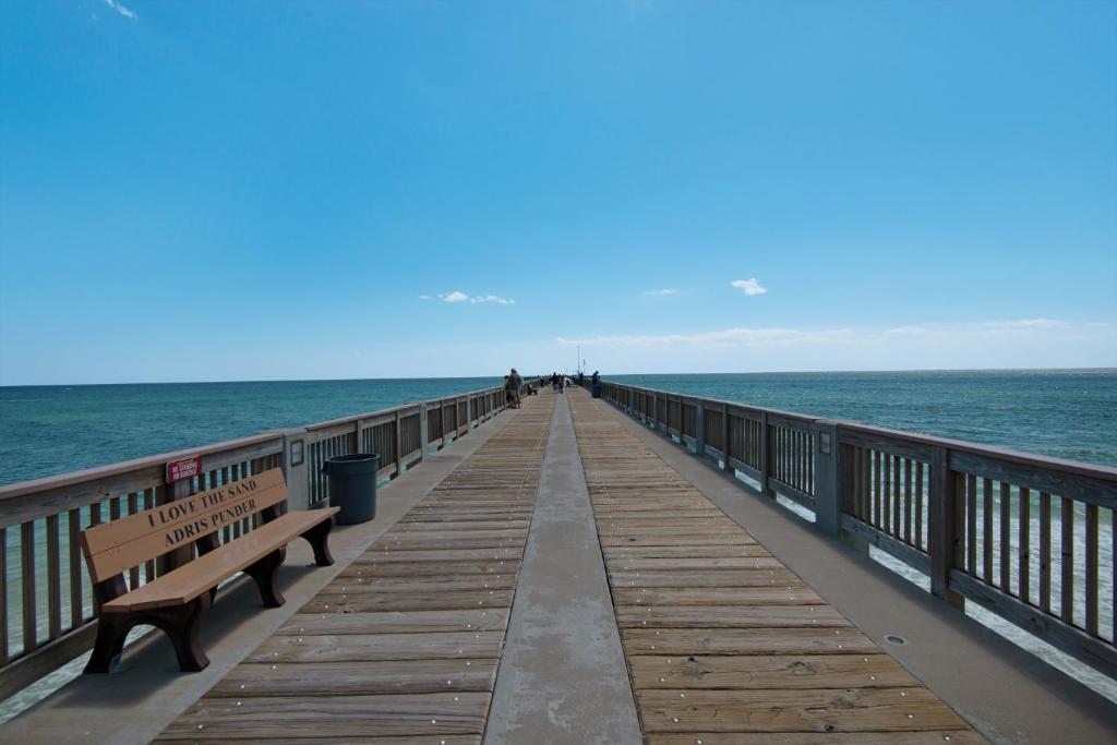 a wooden pier with benches and the ocean at Summer Dayz - Families Love It Here, Just Across from the Beach in Panama City Beach