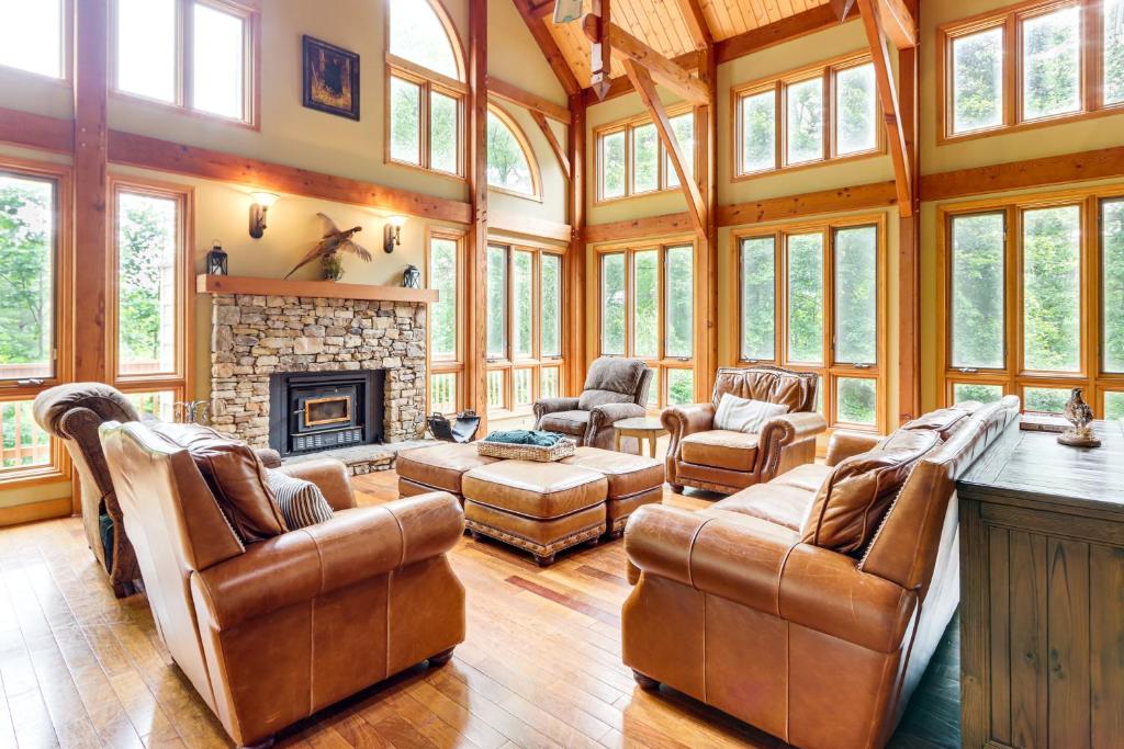 a living room with leather furniture and a fireplace at Game Room and Fireplaces Group Dahlonega Getaway in Dahlonega