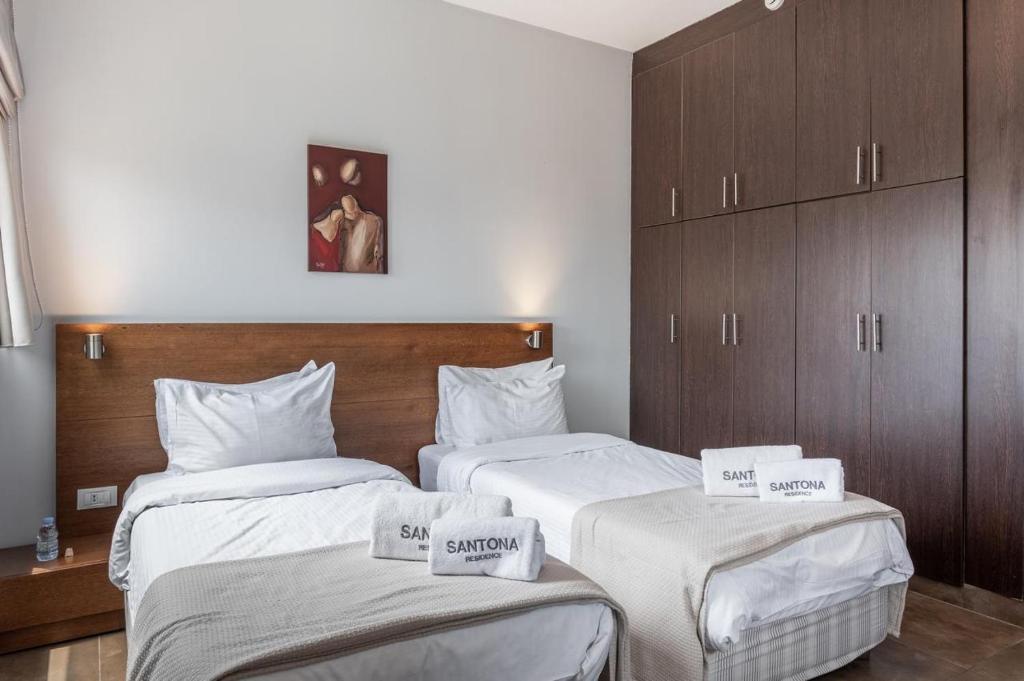 Postel nebo postele na pokoji v ubytování Santona Residence