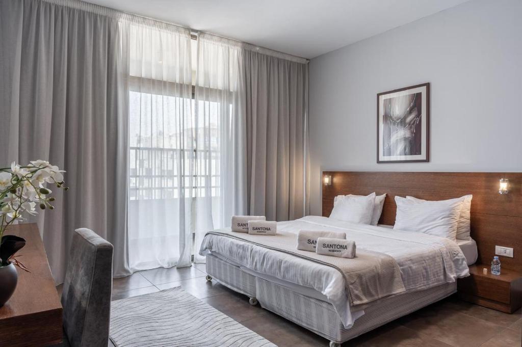 Postel nebo postele na pokoji v ubytování Santona Residence