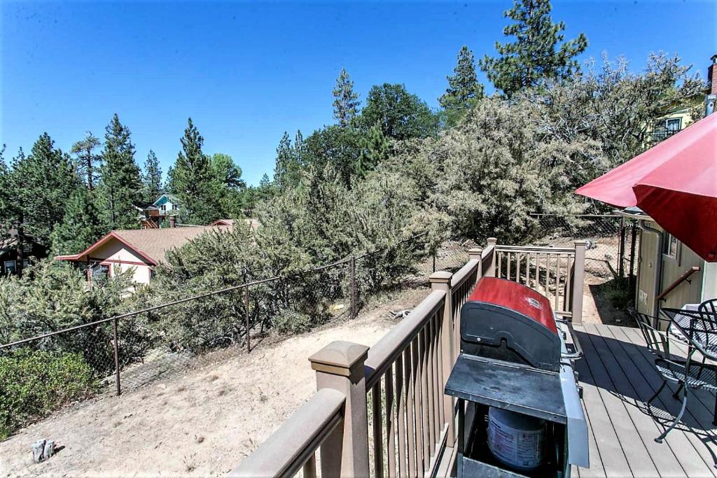 a car is parked on a fence next to a house at Grandpas axe # 1775 in Big Bear Lake