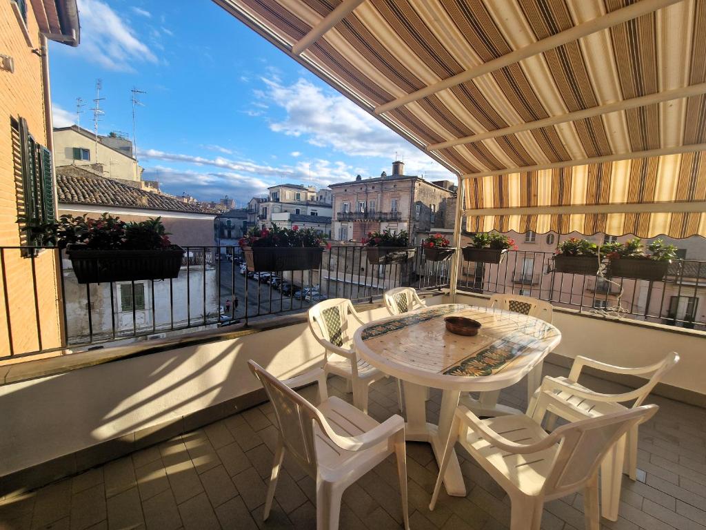 un patio con tavolo e sedie su un balcone di La Terrazza HOUSE a Lanciano
