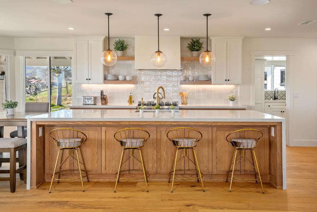 a kitchen with a large island with three bar stools at Mira Vista Manor in Paso Robles