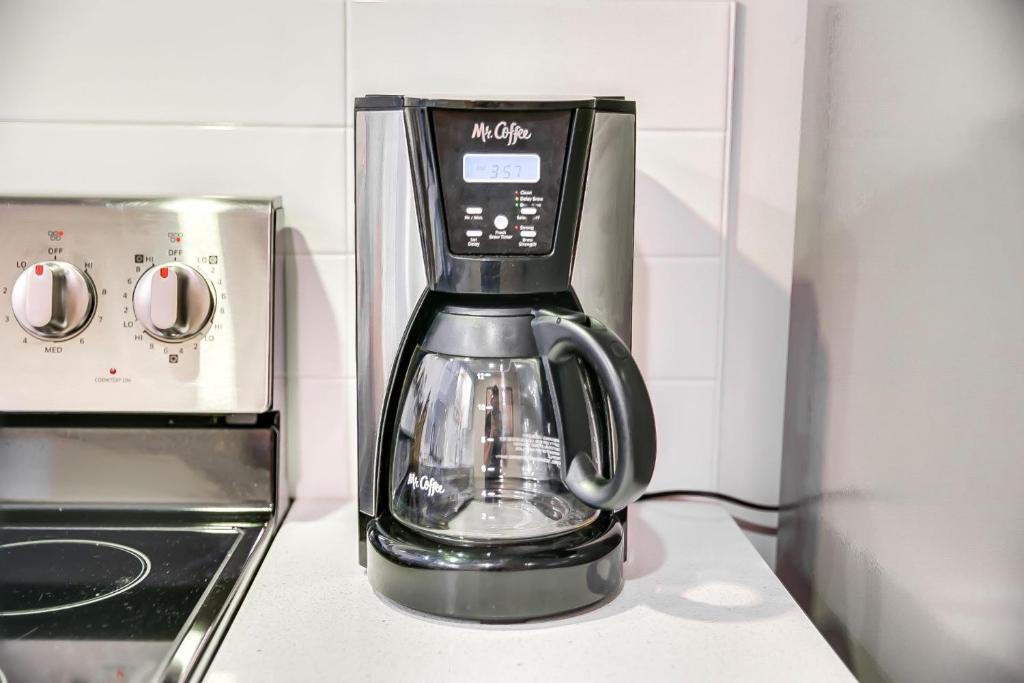 a coffee maker sitting on a counter next to a microwave at Ninth Street Retreat in Boise