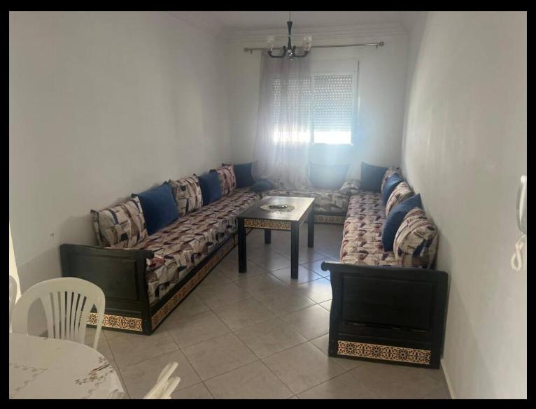 a living room with a couch and a table at Martil 2 bedroom apartment in Martil