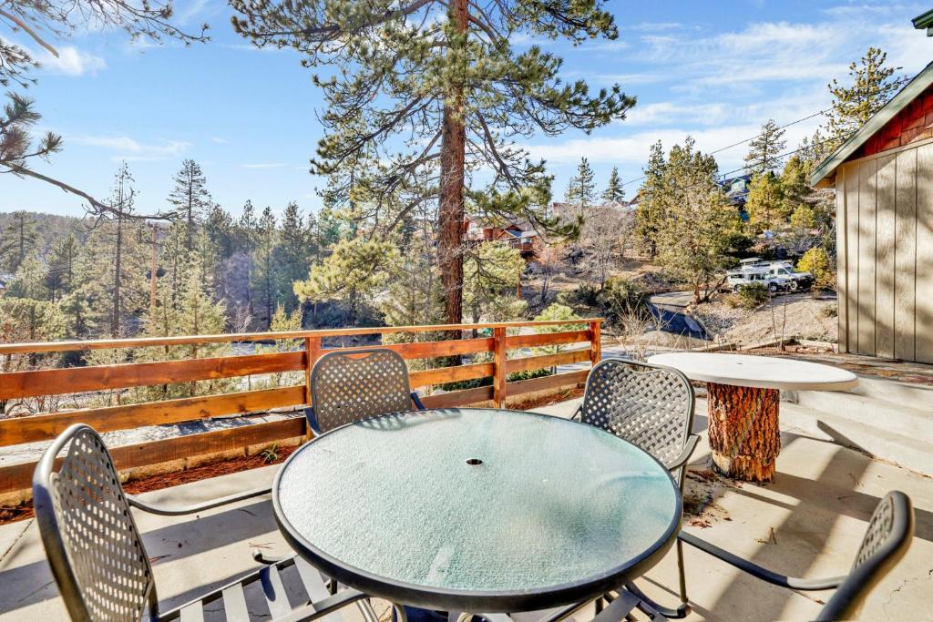 a table and chairs on a patio with a view at Pleasant Pause#1864 in Fawnskin