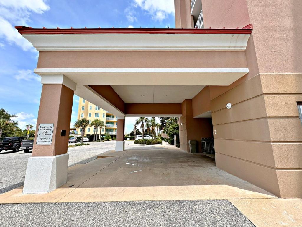 a entrance to a building with a parking lot at The Dunes in Gulf Shores