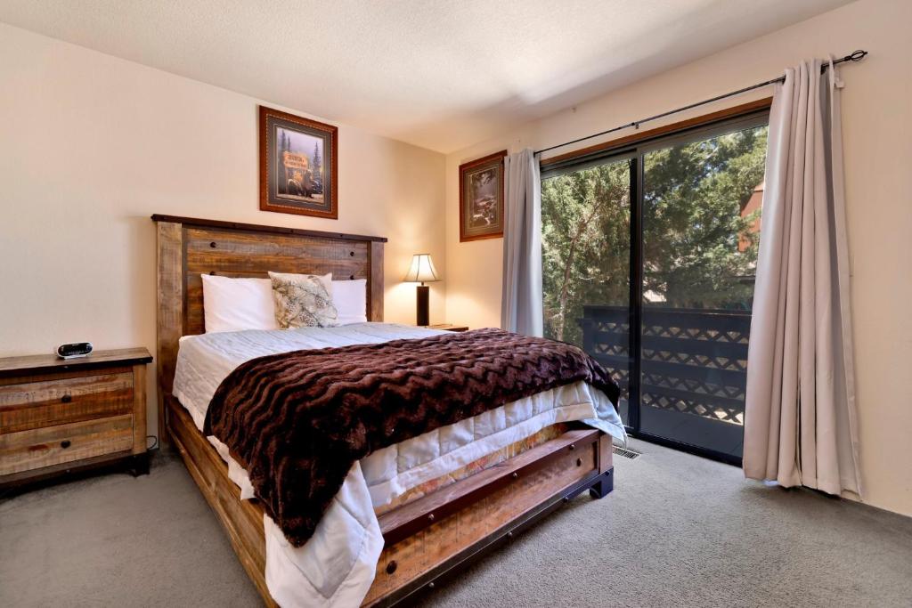 a bedroom with a bed and a large window at Brown bears cabin #1091 in Big Bear Lake