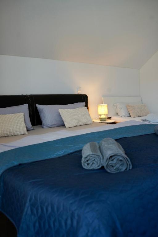 a bed with blue sheets and two towels on it at PrimeBnb Schönbrunn in Schönbrunn