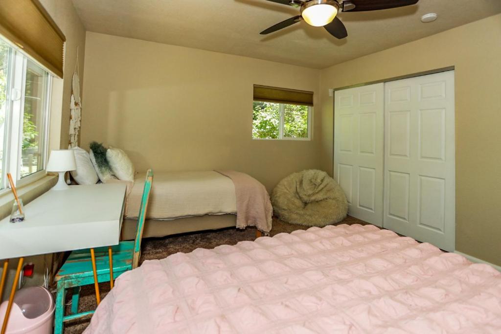 a bedroom with two beds and a ceiling fan at Bohemia big bear #1926 in Big Bear Lake
