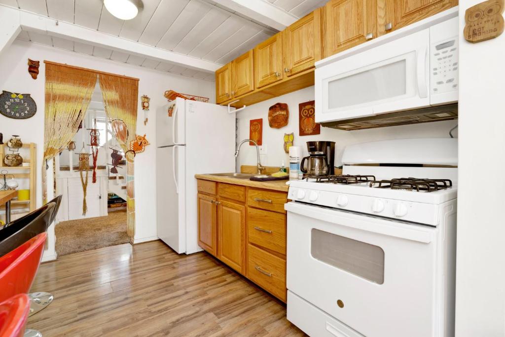a kitchen with white appliances and wooden cabinets at Sunrise cottage #1800 in Big Bear City
