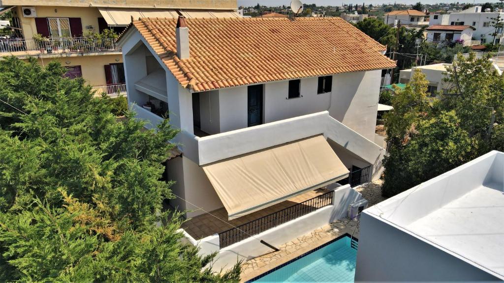 an aerial view of a house with a swimming pool at Dionysus Blue Sky in Egina