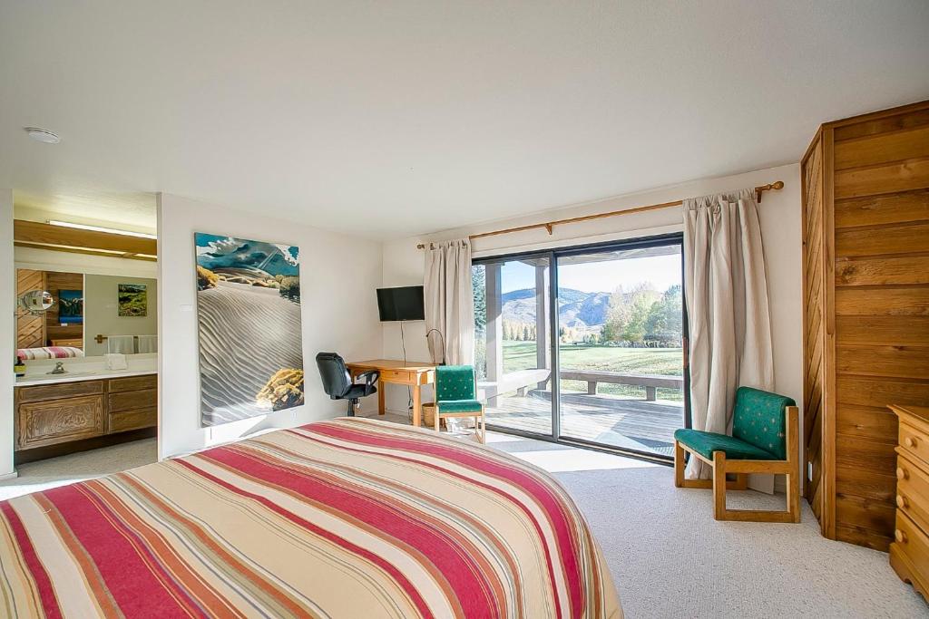 a bedroom with a bed and a sliding glass door at Teleidoscope Retreat in Sun Valley