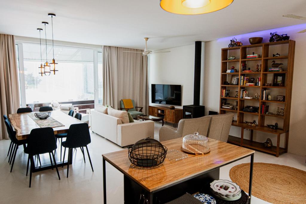 a living room with a table and a dining room at In53 Guest House in Ponta Delgada