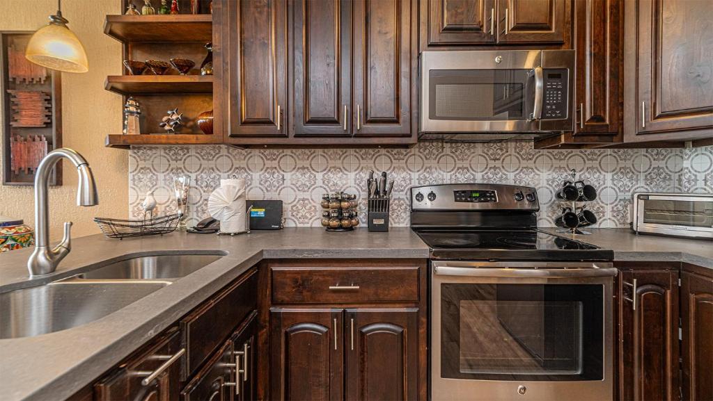 a kitchen with a sink and a stove top oven at Sonoran Sun in Campo del Medio
