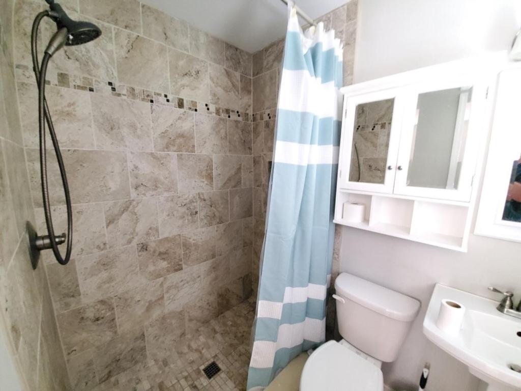 a bathroom with a shower and a toilet and a sink at Floridays in Saint Augustine Beach