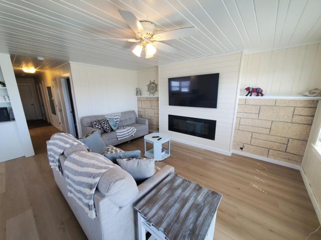 a living room with a couch and a ceiling fan at The Dunes in St. Augustine