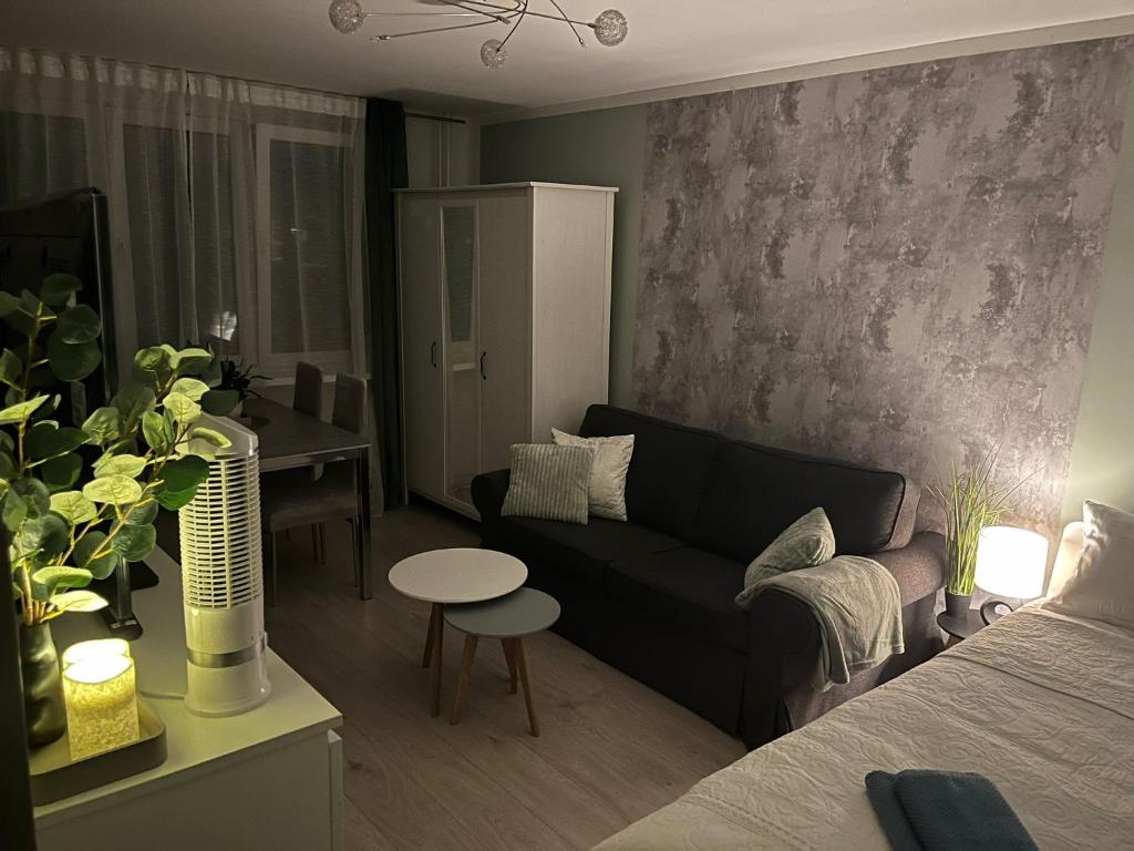 a living room with a couch and a table at Apartament Piaskowa Mountain & Coffee in Wałbrzych