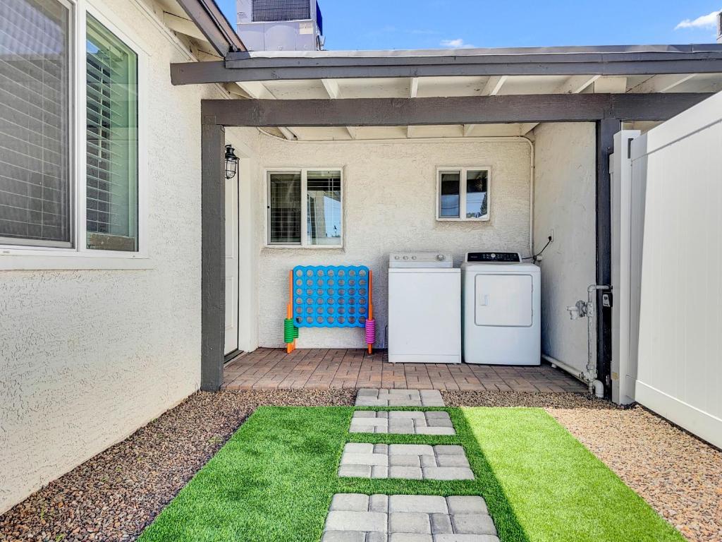 a patio with two refrigerators and a blue chair at Drew 253 Mesa in Mesa